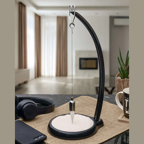 Foucault Pendulum by Heebie Jeebies.  Its rhythmic motion inscribes beautiful patterns in the sand. 